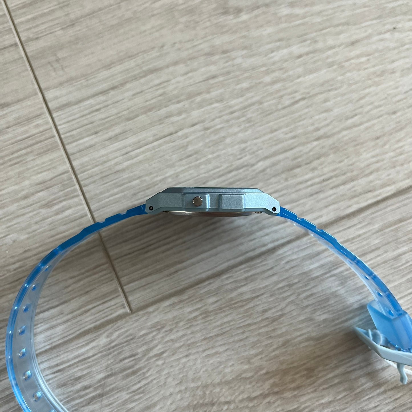 Blue plastic ring with metal component on a wooden surface