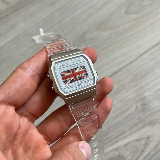 Custom Casio F-91W Clear/Transparent digital watch featuring a United Kingdom Flag filter screen. Slim 8.5 mm profile, lightweight 21 g build and flexible bio-based resin band ensure lasting comfort. Includes alarm, stopwatch, and microlight function for everyday functionality.