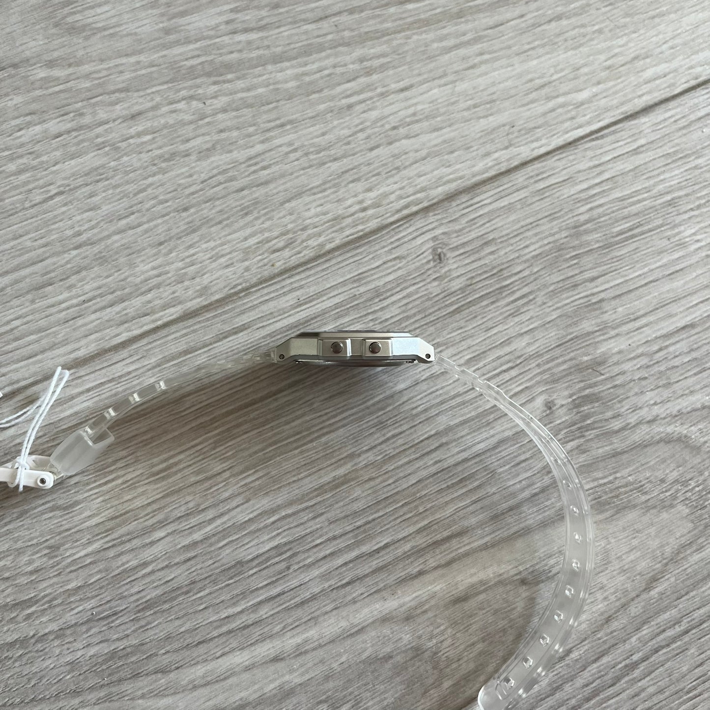 Clear plastic visor with metal bracket on a wooden surface