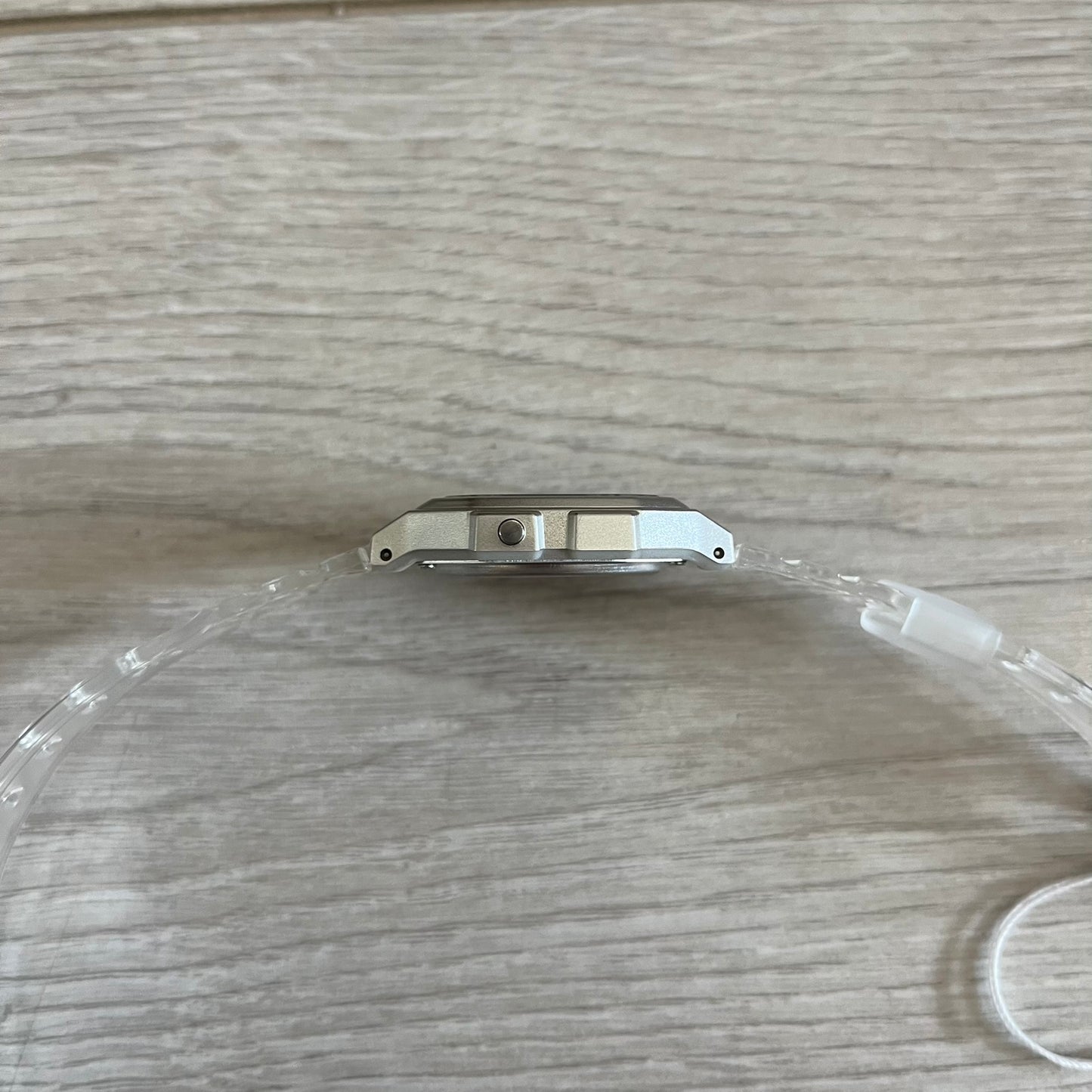 Clear plastic watch band on a wooden surface