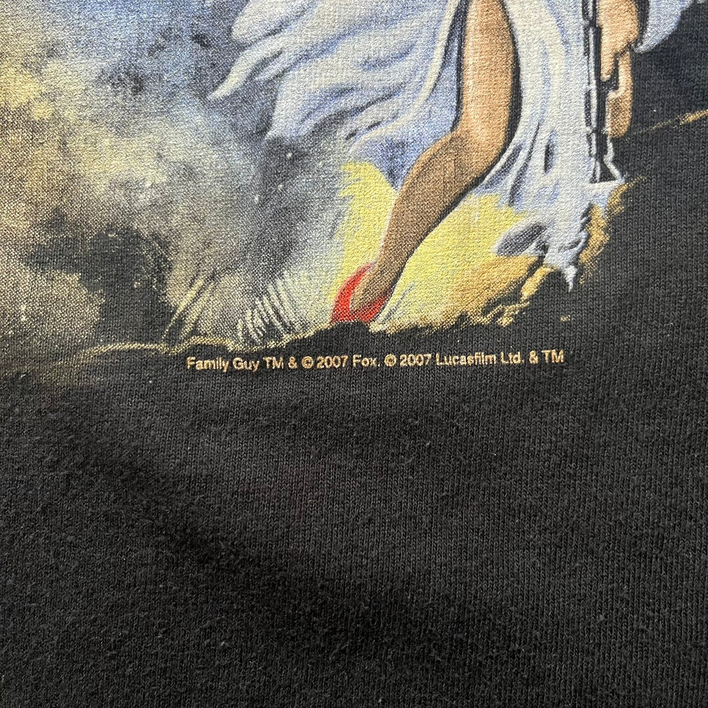 Black t-shirt with a graphic design of a character from 'Family Guy' and copyright information.