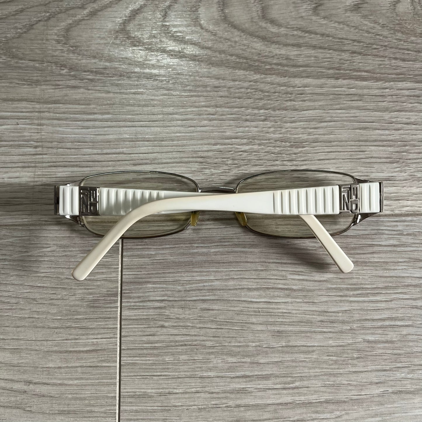 Sunglasses with a metallic frame on a wooden surface