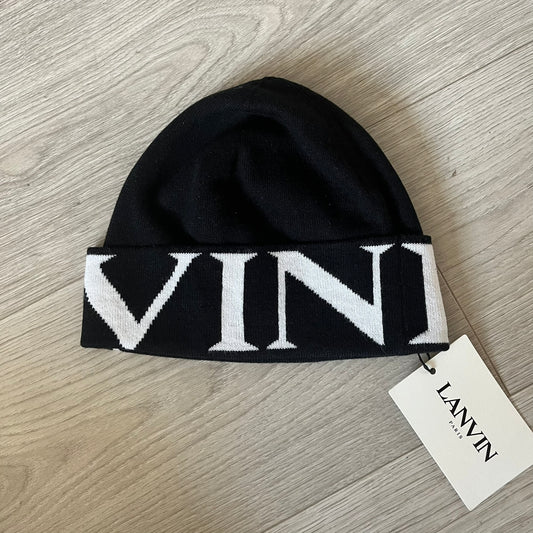 Black beanie with white logo on a wooden surface, featuring a Lanvin tag.