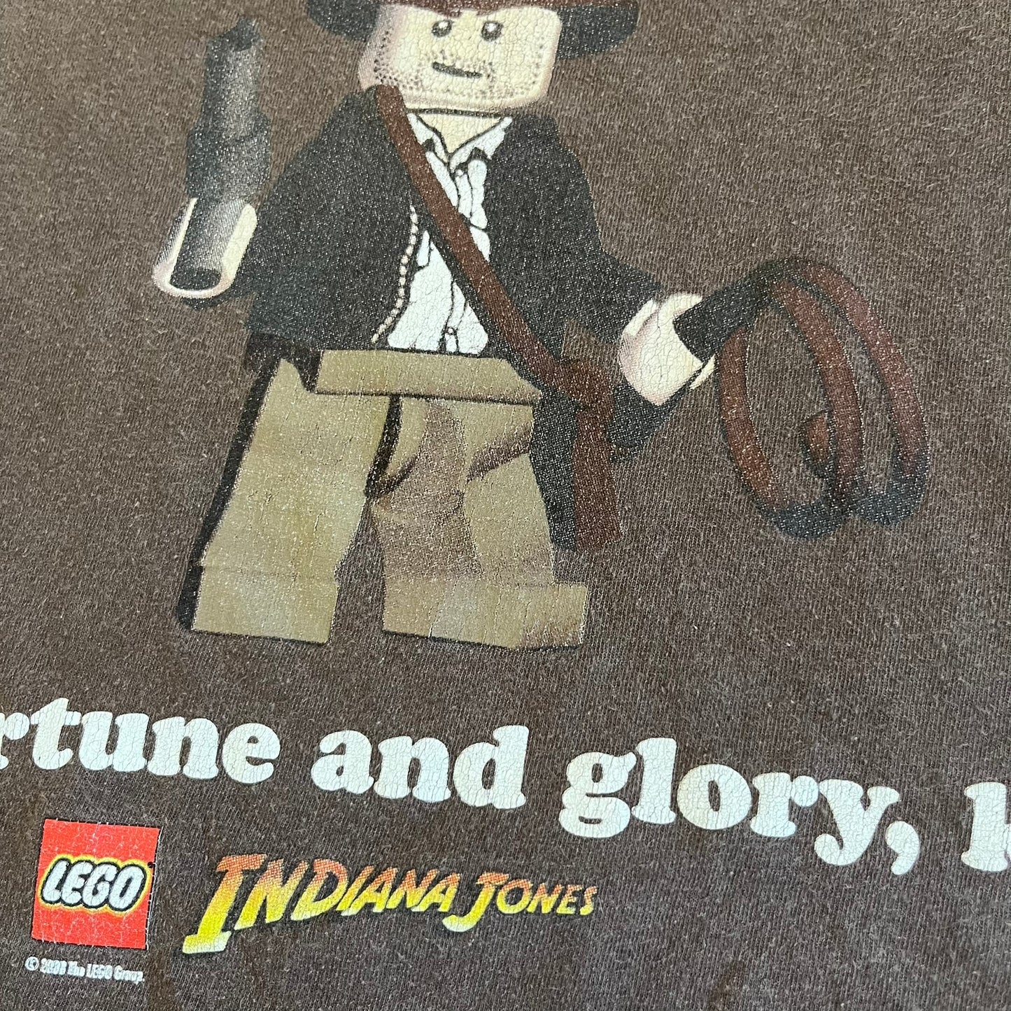 LEGO Indiana Jones minifigure with text and LEGO logo on a dark background