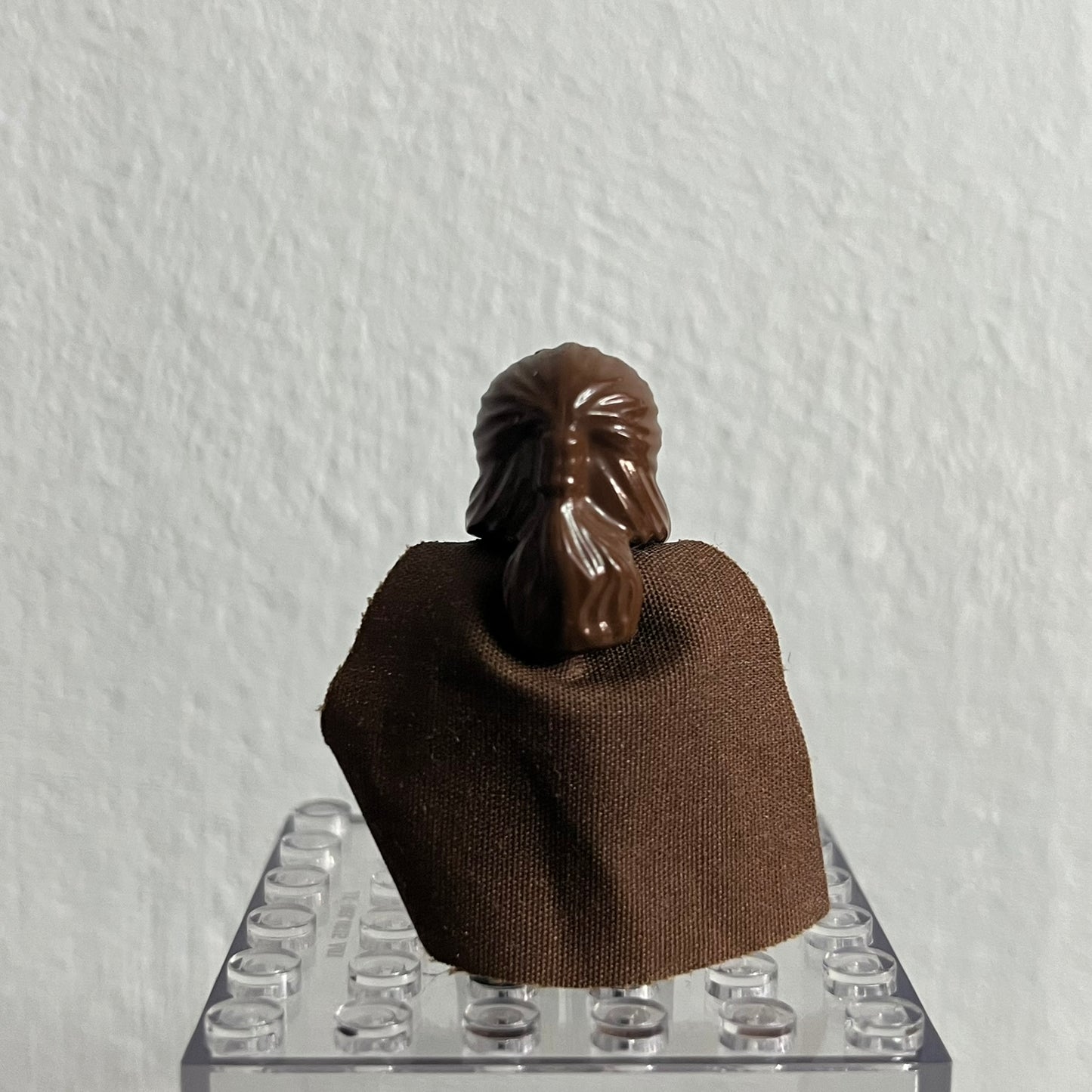 Brown horse head figure on a clear square base against a white background