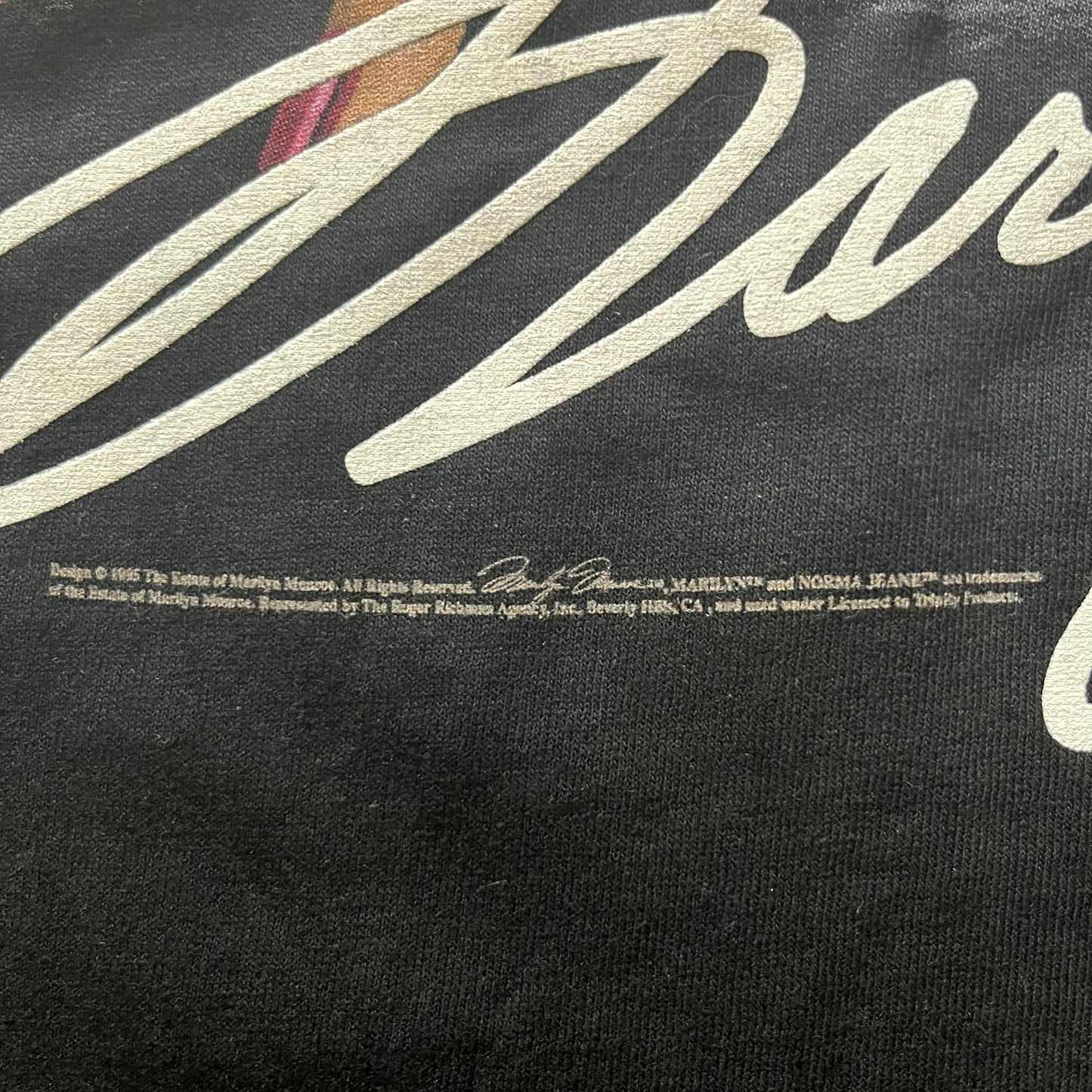 Black t-shirt with white text and logo on a black background