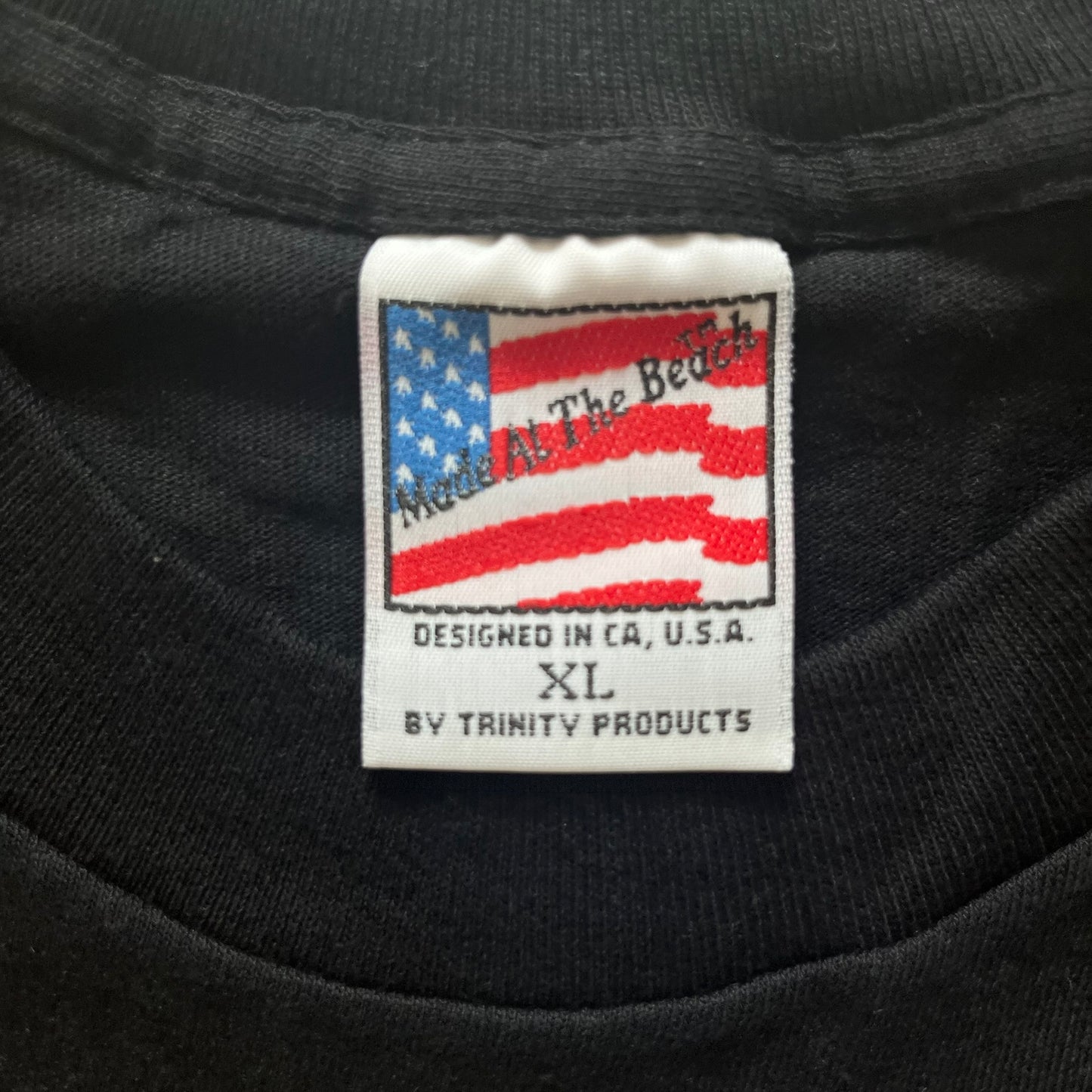 Black shirt with a label featuring an American flag and text