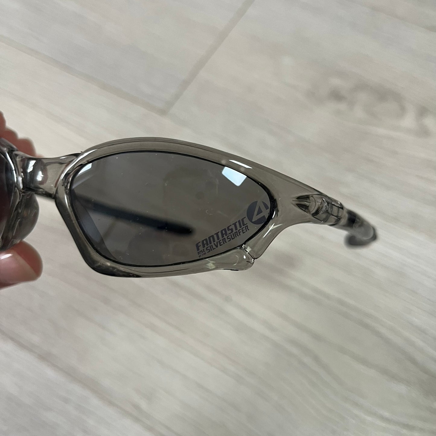 Sunglasses with a reflective surface on a light wooden floor