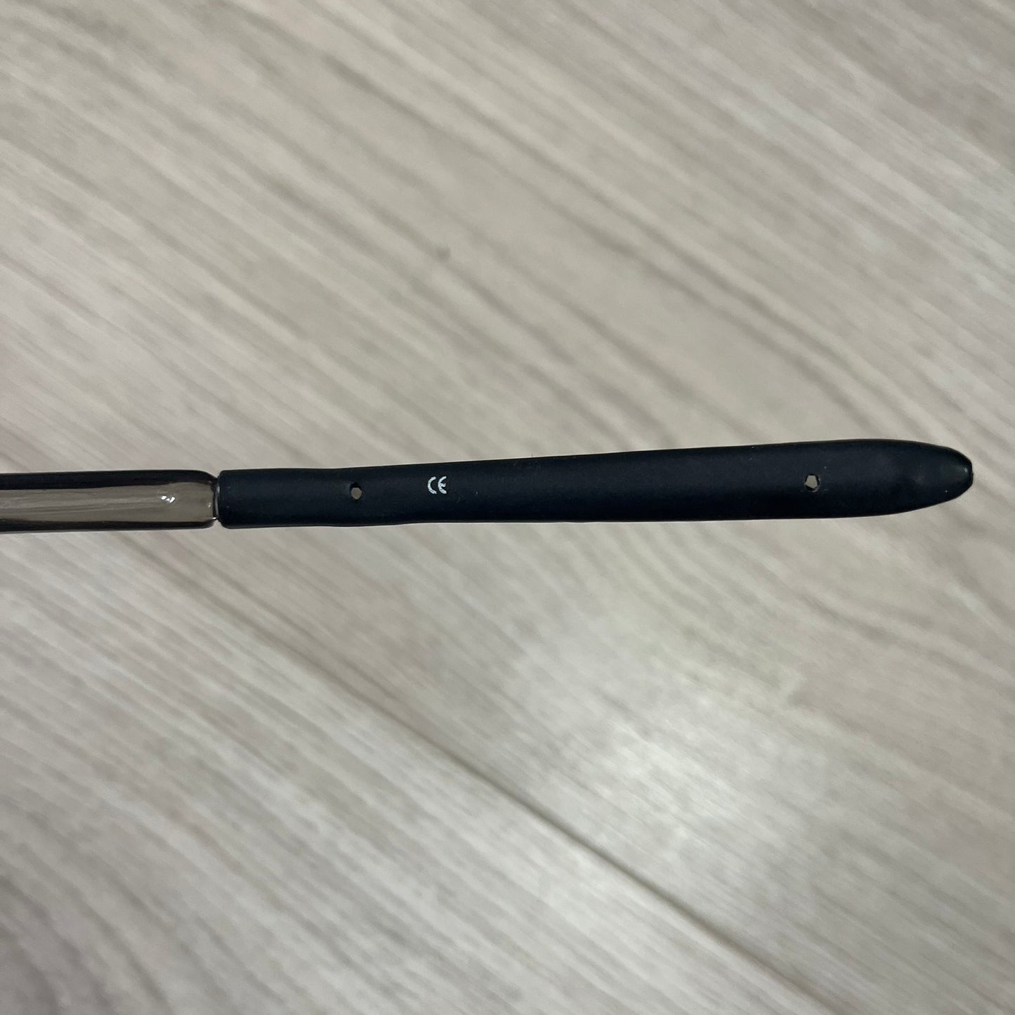 Black and silver tool on a textured surface