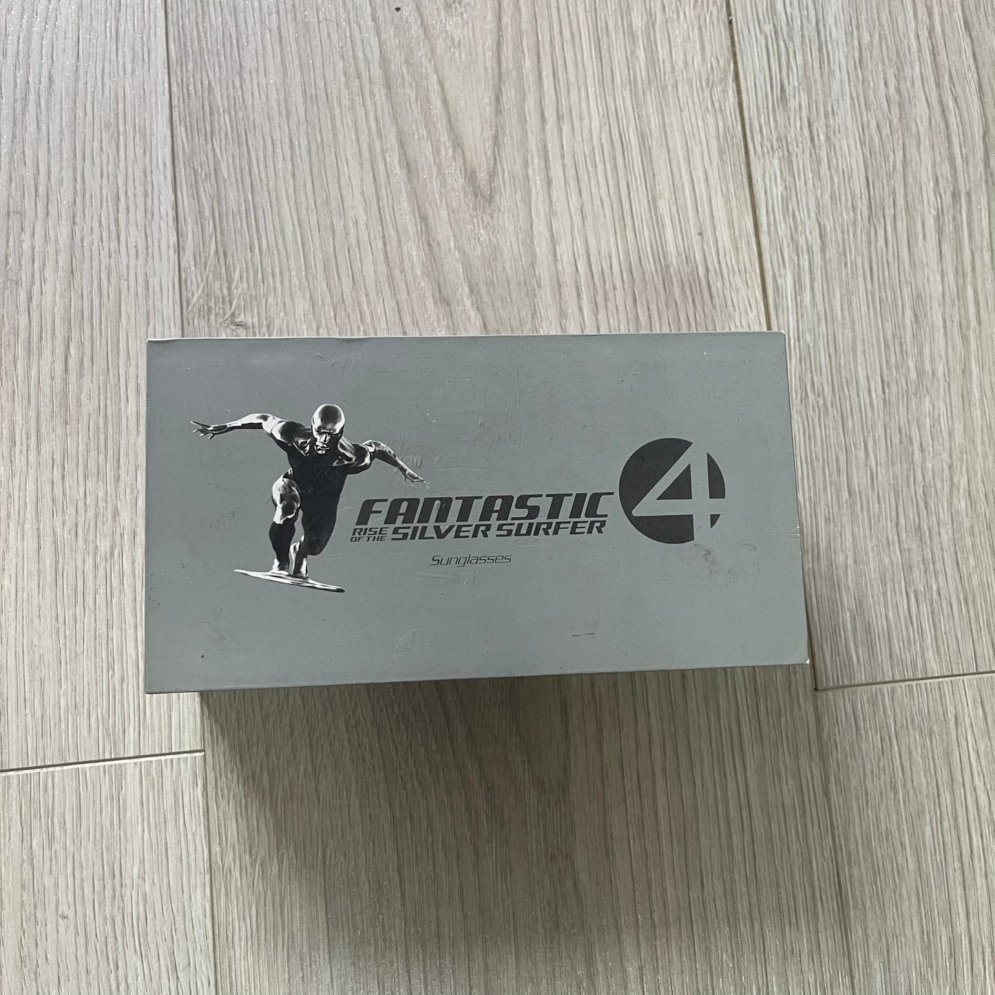 Box with 'Fantastic Four' logo featuring a character on a wooden floor