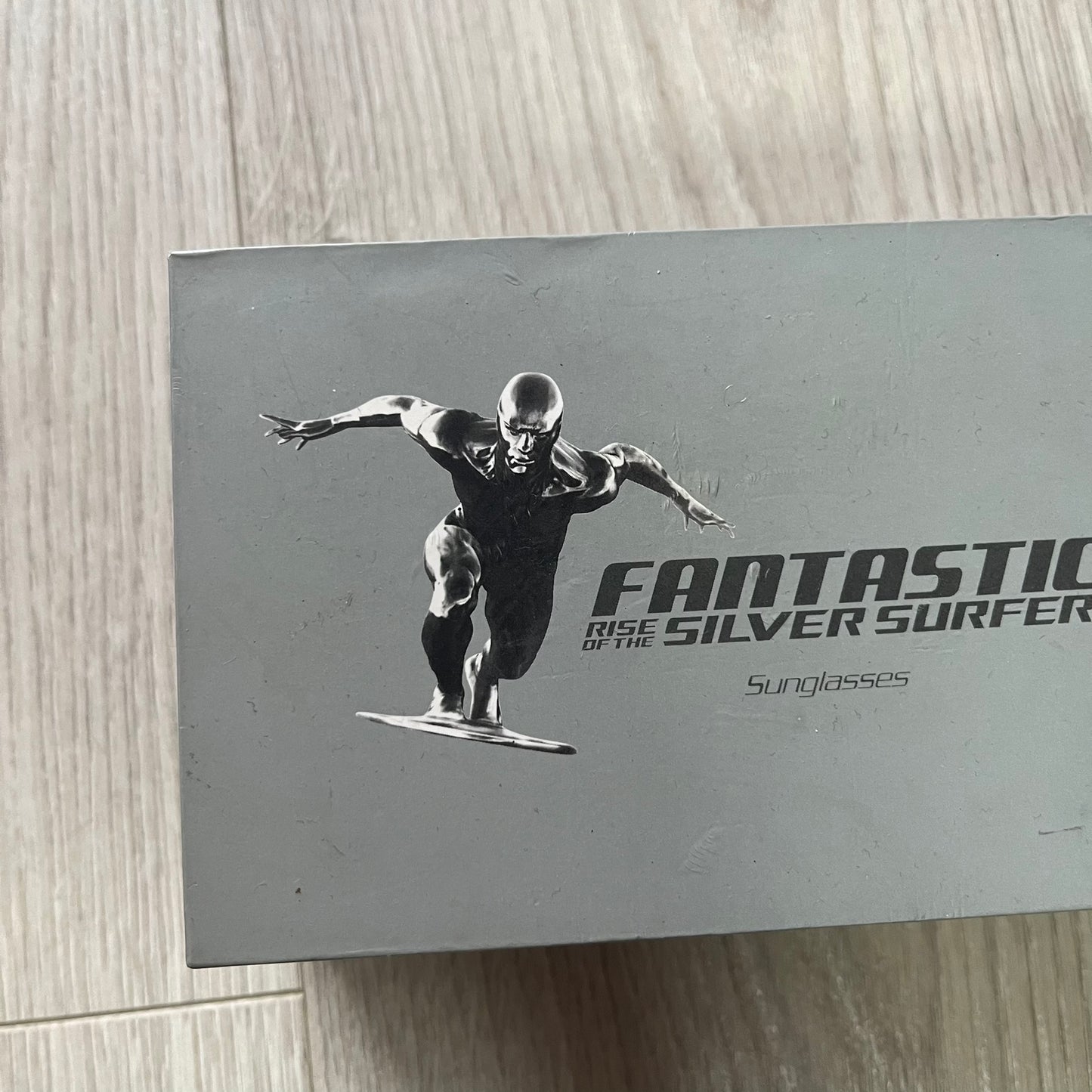 Sunglasses packaging with a graphic of a character on a surfboard, featuring the text 'Fantastic Silver Surfer'.