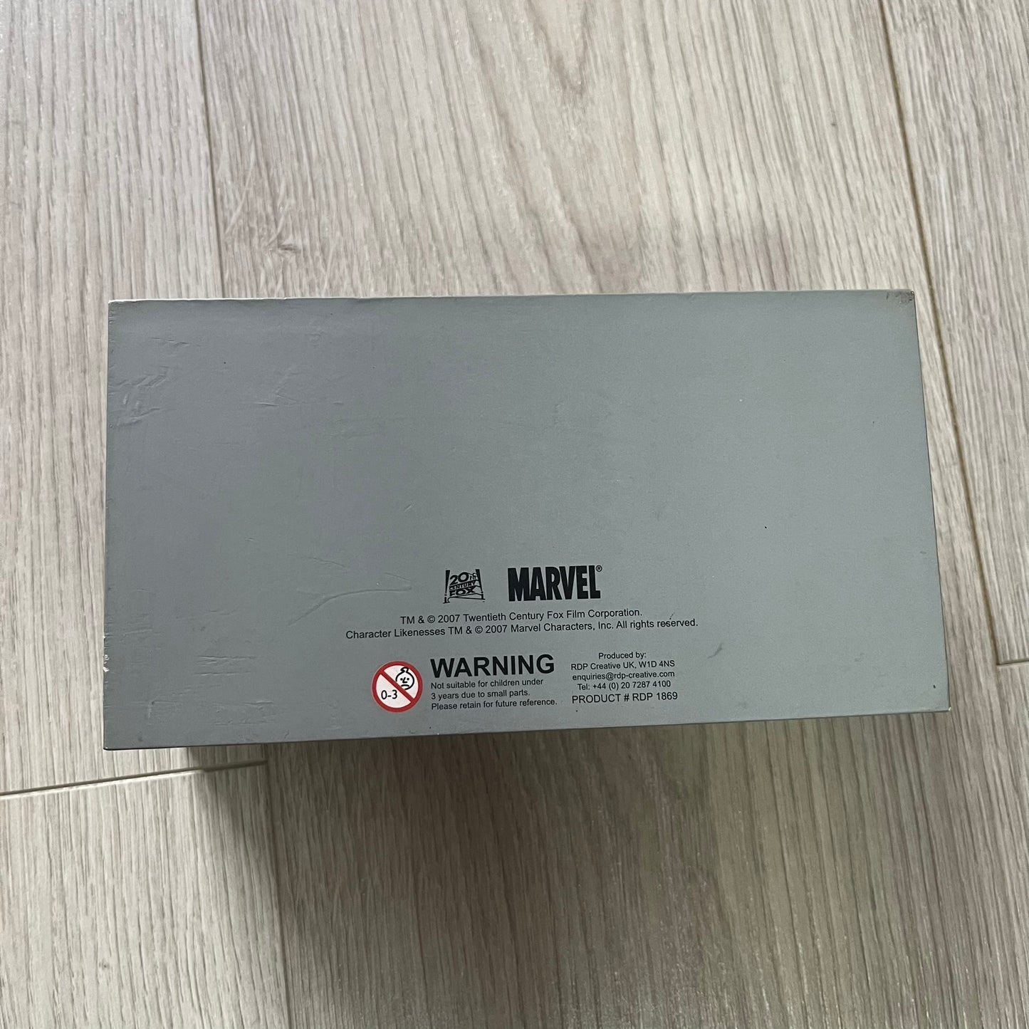 Gray Marvel box on a light wooden surface