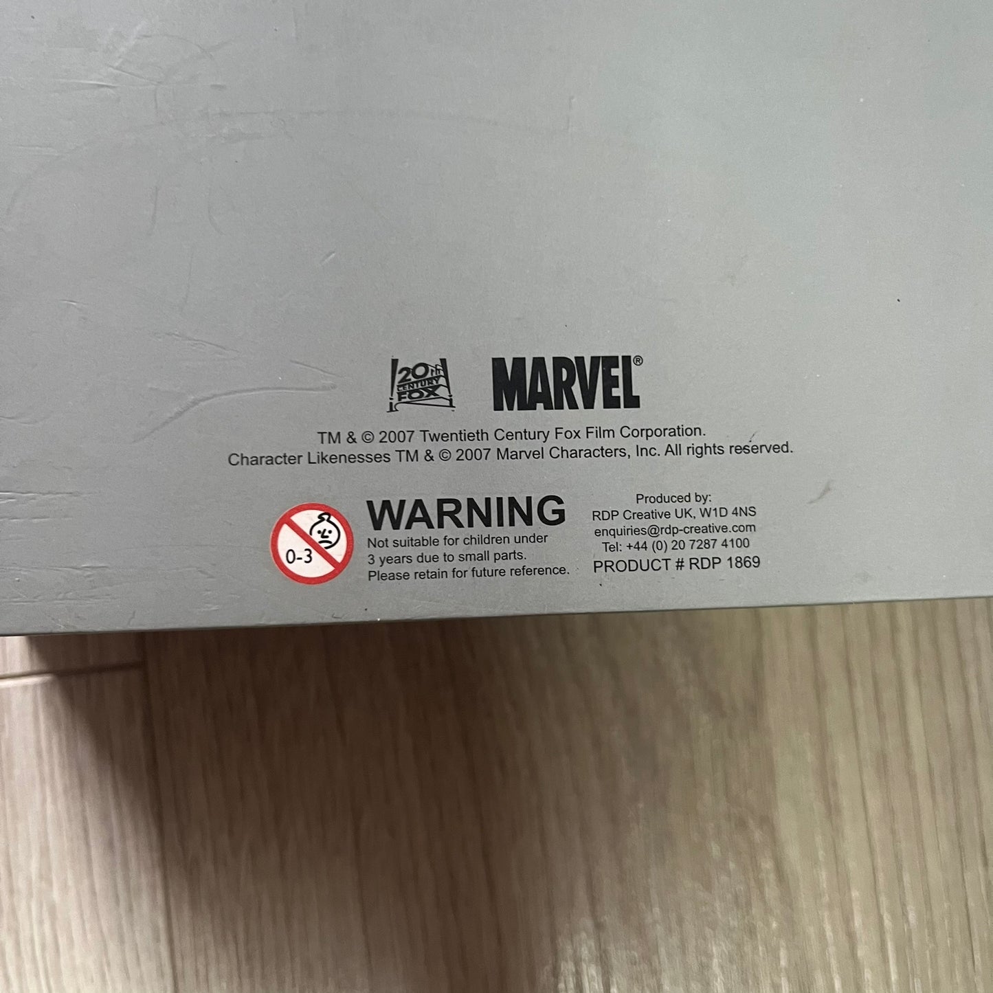 Marvel product label with warning and copyright information on a gray background