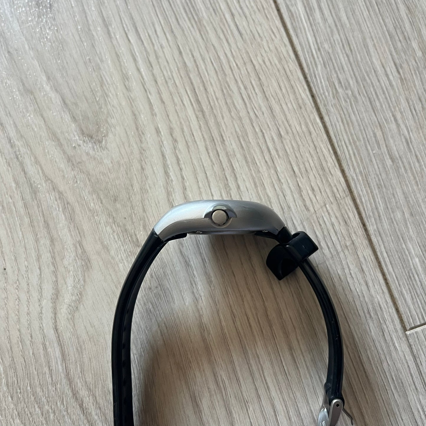 Black and silver bridle on a wooden floor
