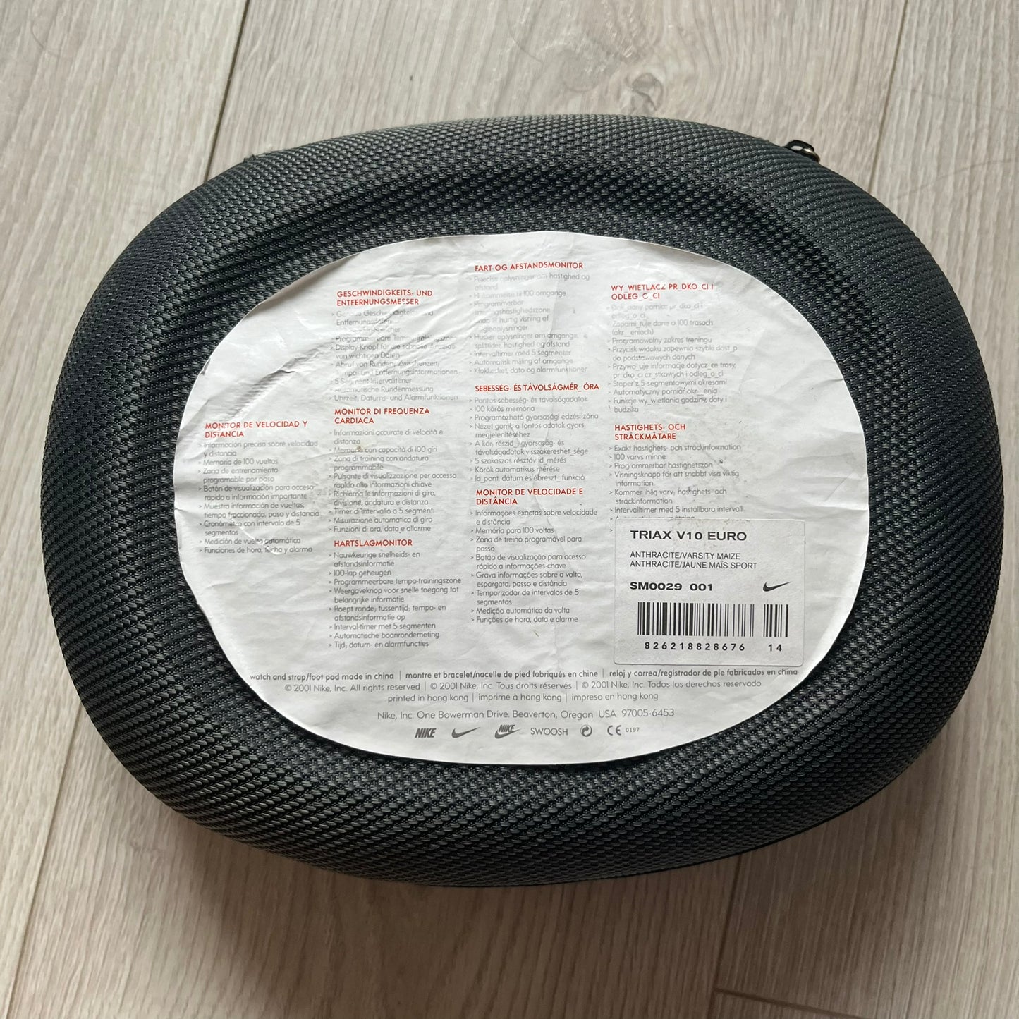 Black tire with a label on a wooden floor