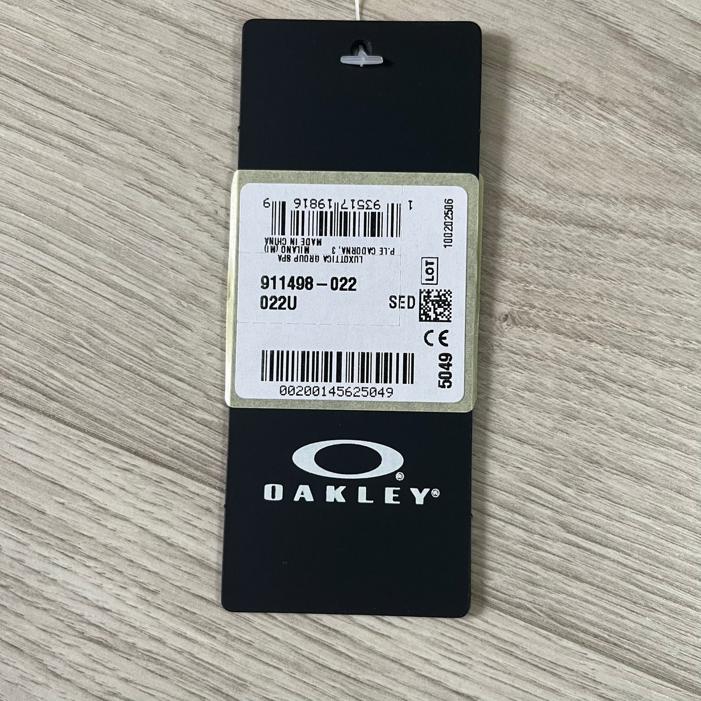 Oakley product tag on a wooden surface