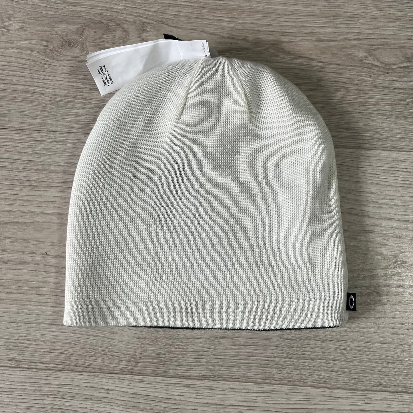 Gray knit beanie on a wooden surface