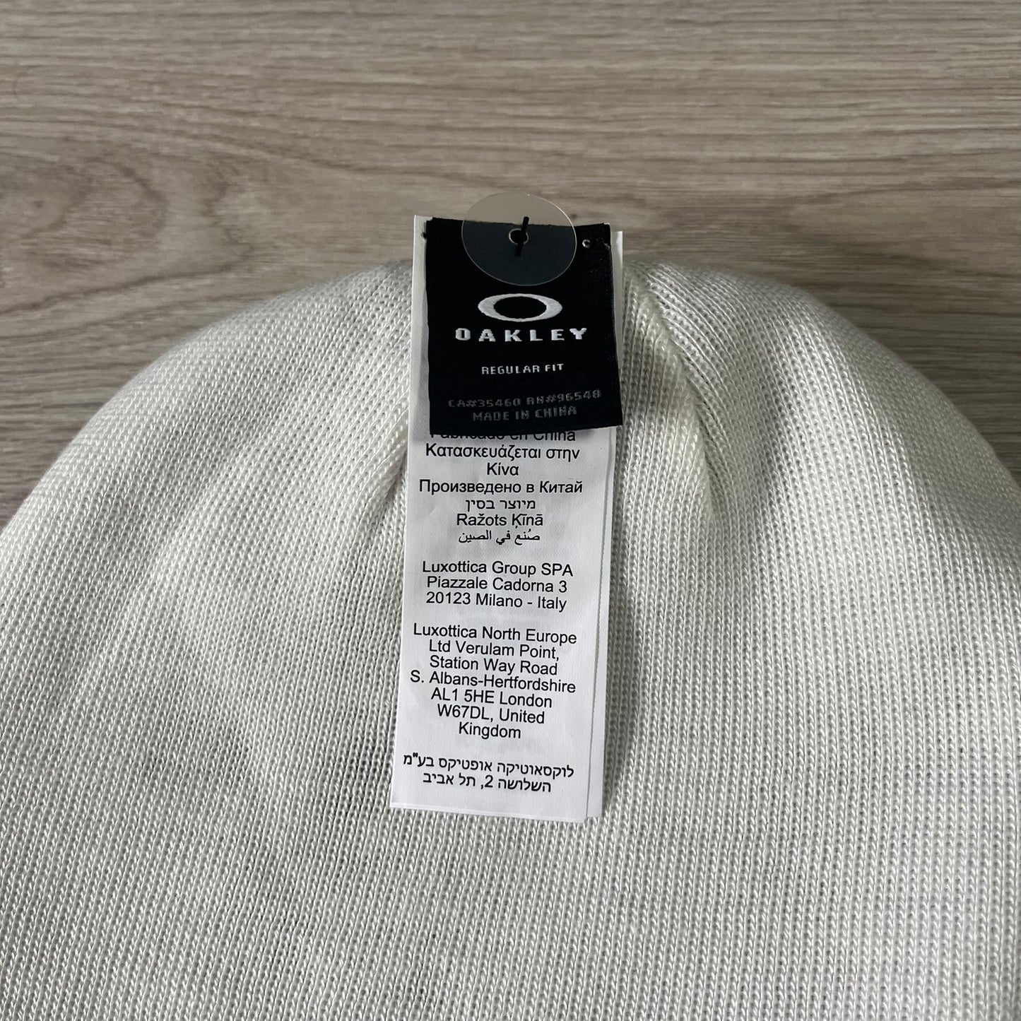 Gray beanie with Oakley tag on a wooden surface