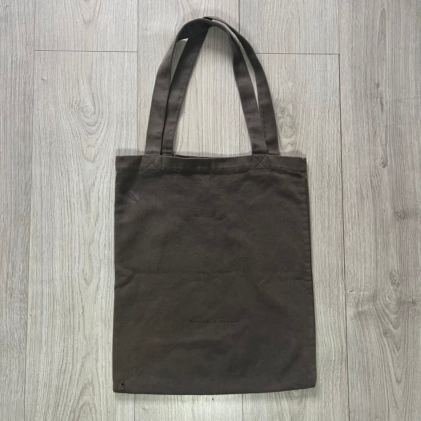 Black tote bag on a wooden surface