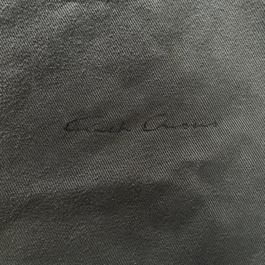 Close-up of a textured gray fabric with a signature on it