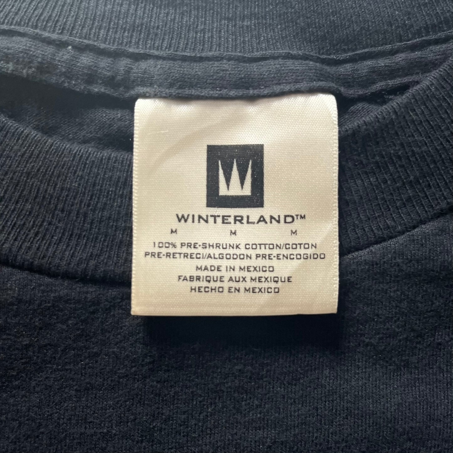 Label on a dark fabric with 'Winterland' branding and text.