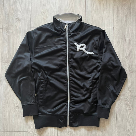 Black jacket with a logo on a wooden surface