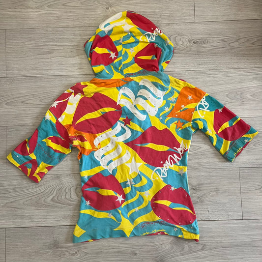Colorful hoodie with abstract patterns on a wooden floor