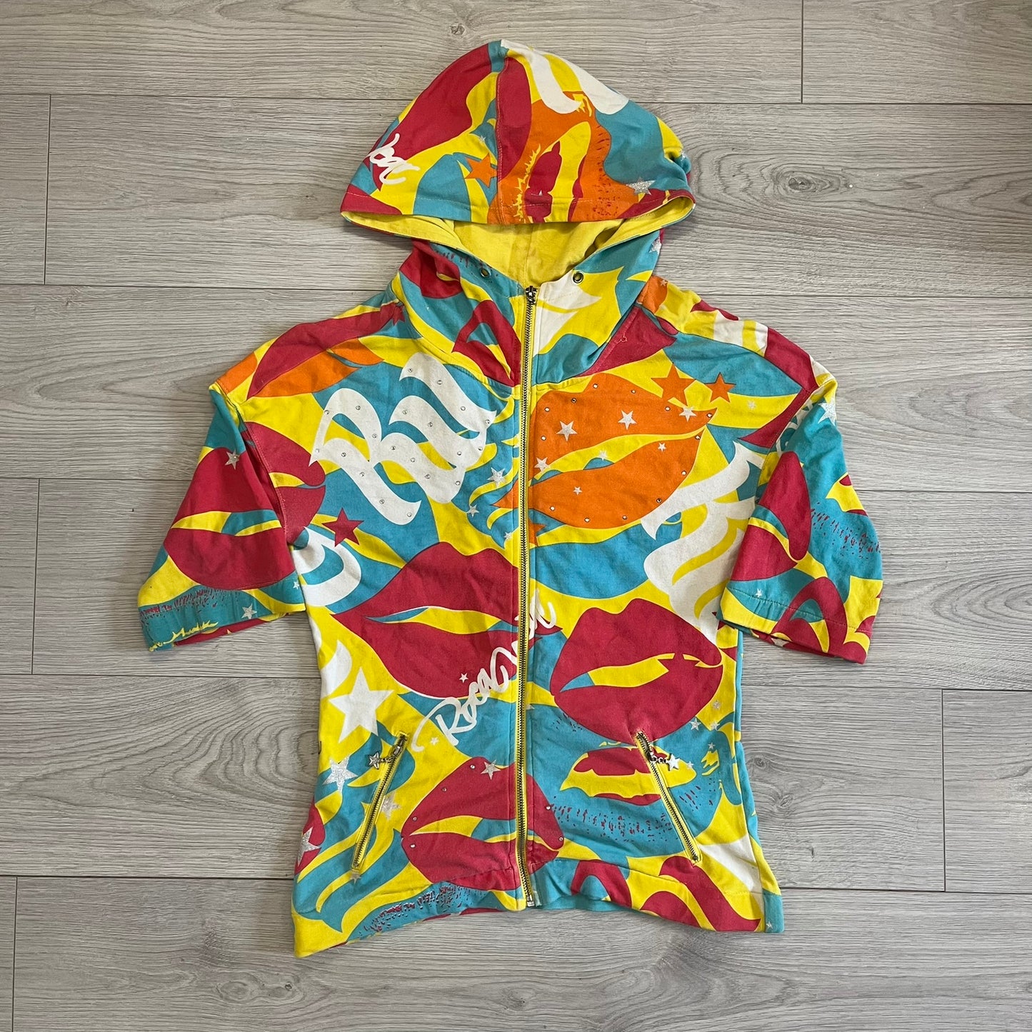Colorful hoodie with abstract patterns on a wooden floor