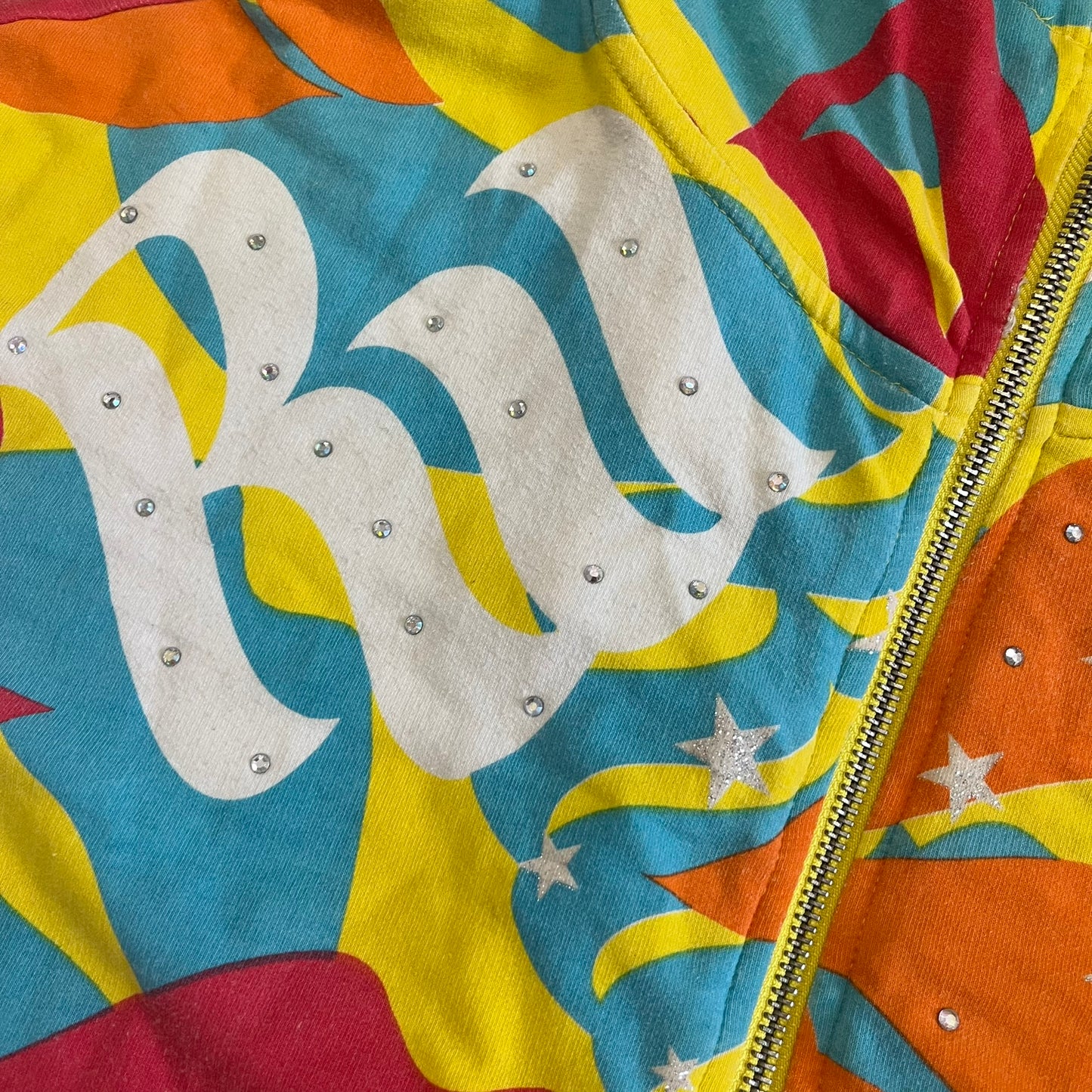 Colorful jacket with a prominent brand logo and decorative elements.