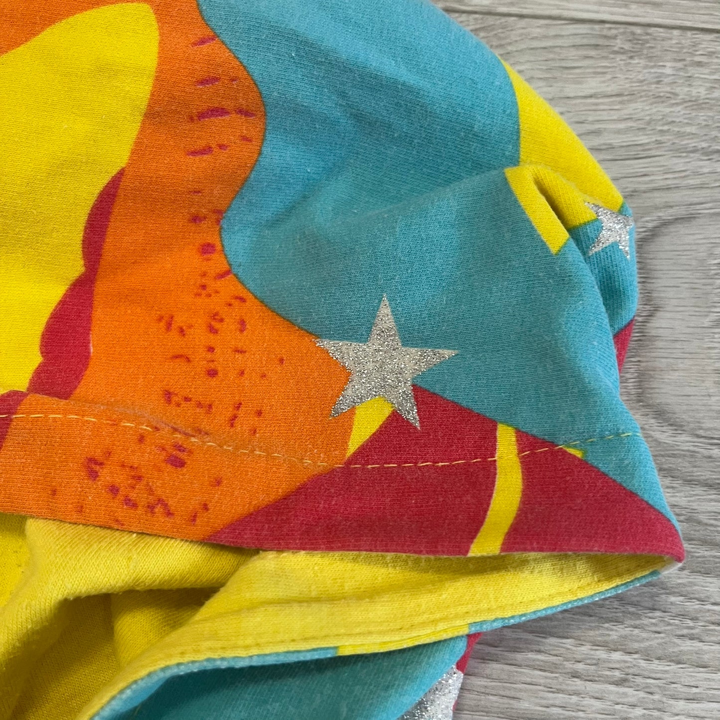 Colorful fabric with star pattern on a wooden surface