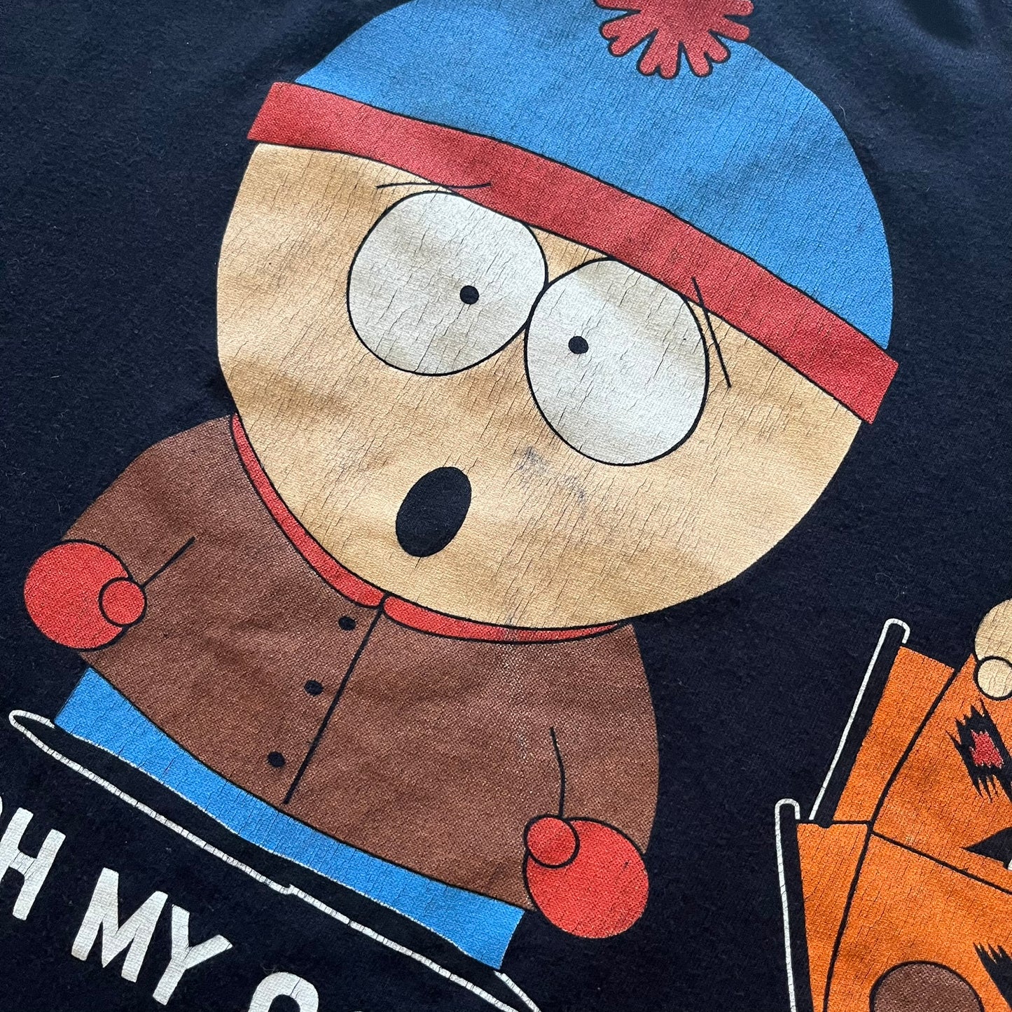 Cartoon character with a blue hat and brown coat on a dark background