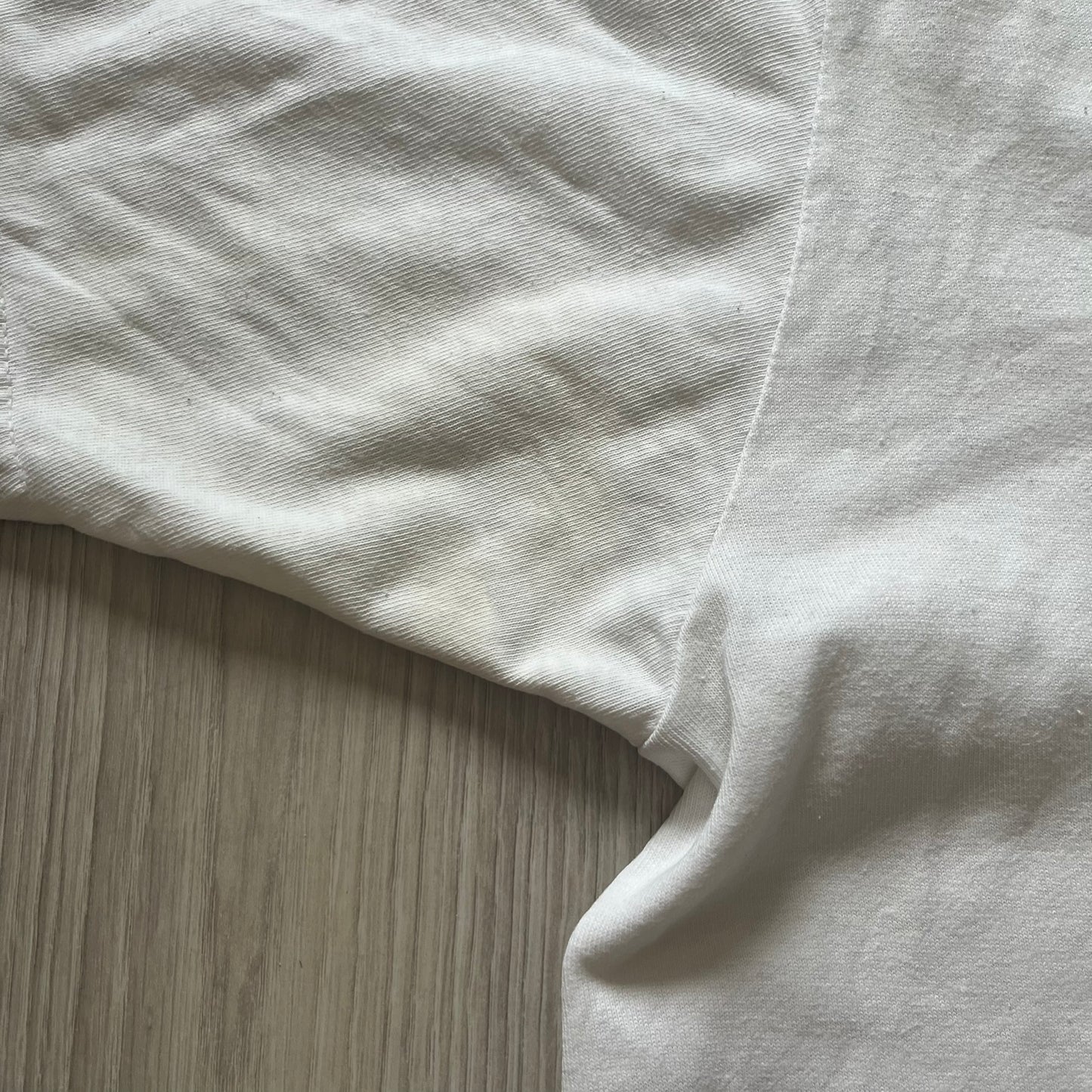 Close-up of a white fabric corner on a wooden surface