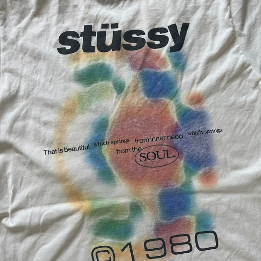 White t-shirt with colorful tie-dye design and 'stussy' branding