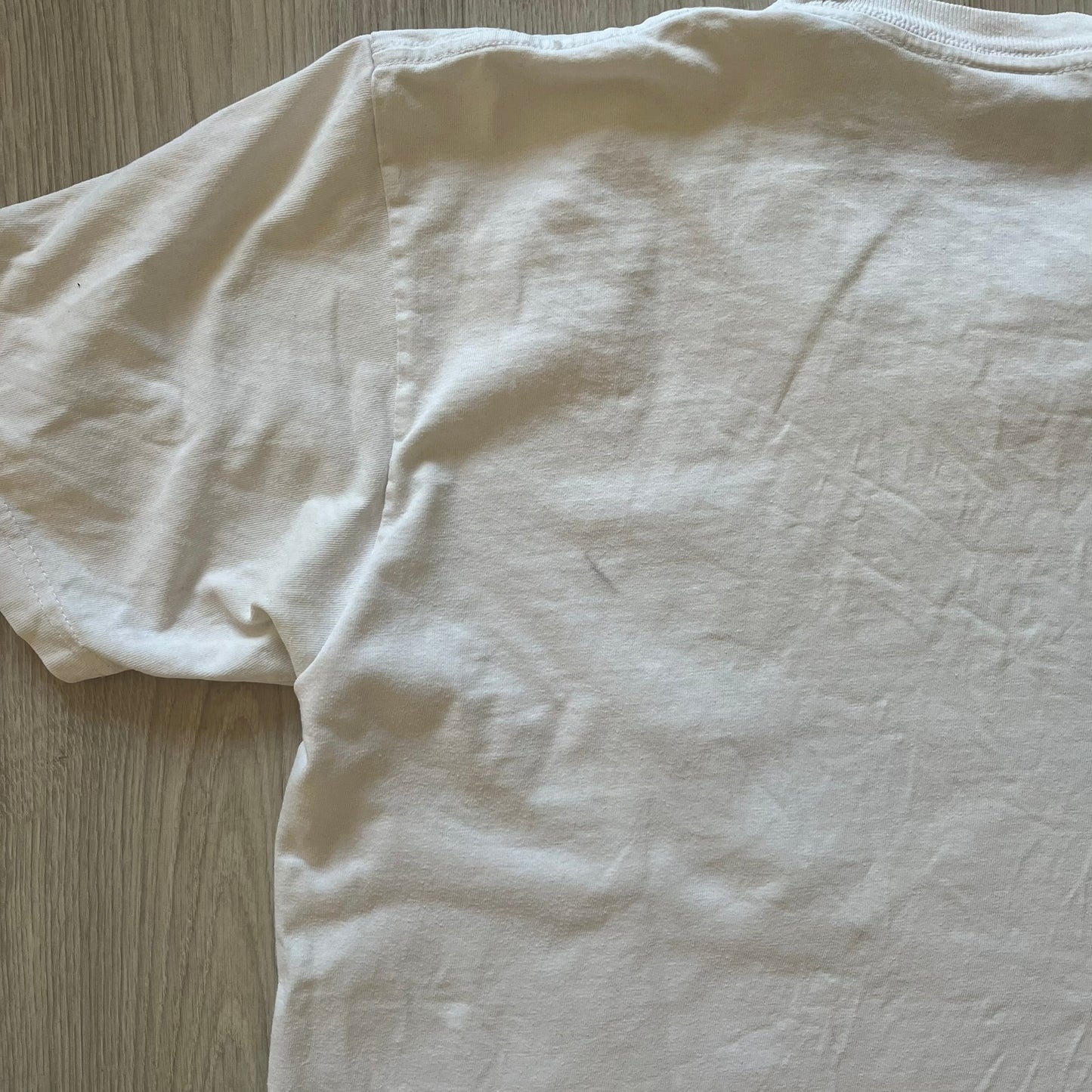 White t-shirt on a wooden surface