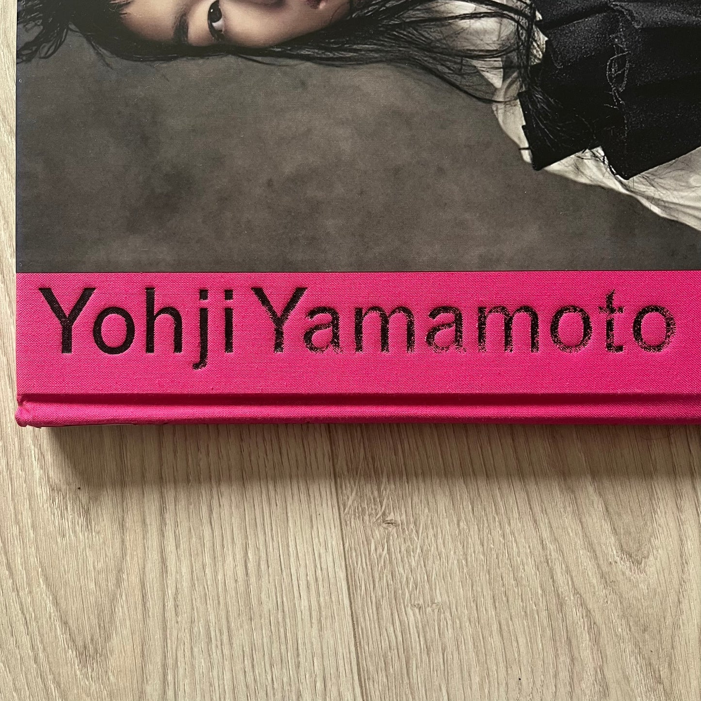 Yohji Yamamoto product with a person lying on a gray surface