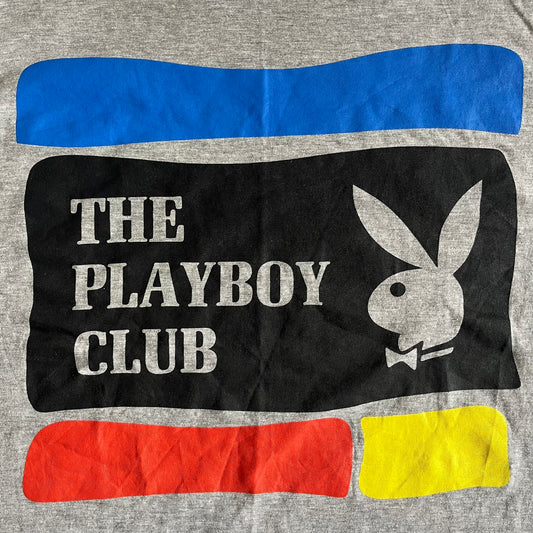 Gray t-shirt with Playboy Club logo and colors on a gray background