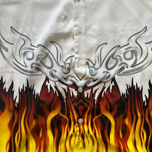 White shirt with silver tribal design on the chest and flames on the sleeves