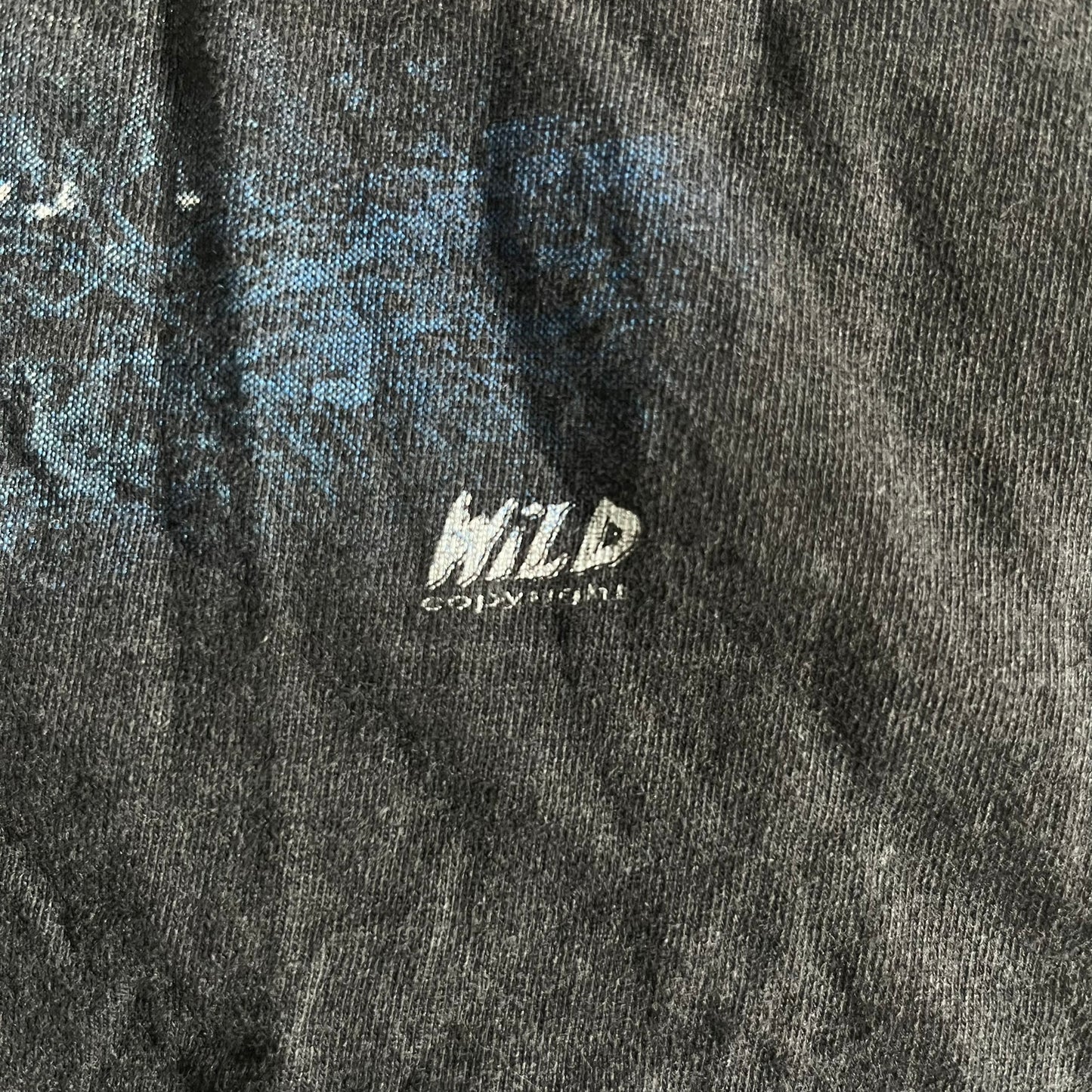 Close-up of a textured fabric with 'WILD' branding.
