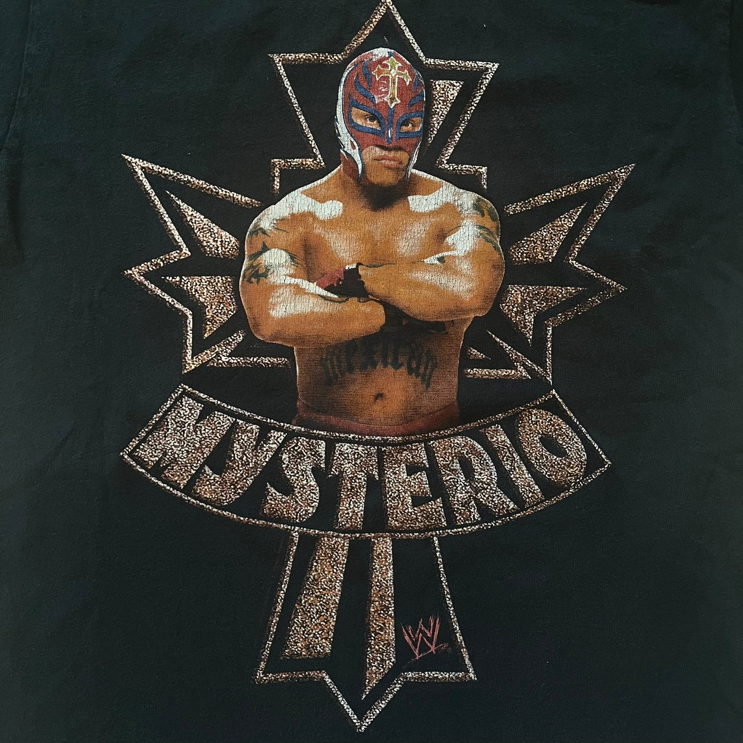Black t-shirt with a wrestler graphic and 'Mysterio' text on a dark background