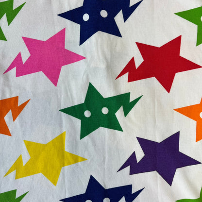 A Bathing Ape 2014 Milo Multicolor Sta Polo is a white, 100% cotton BAPE polo featuring an all-over print of multicolor STA (shooting star) graphics in pink, green, blue, yellow, red (and more), some featuring eyes. It includes branded Bape buttons.