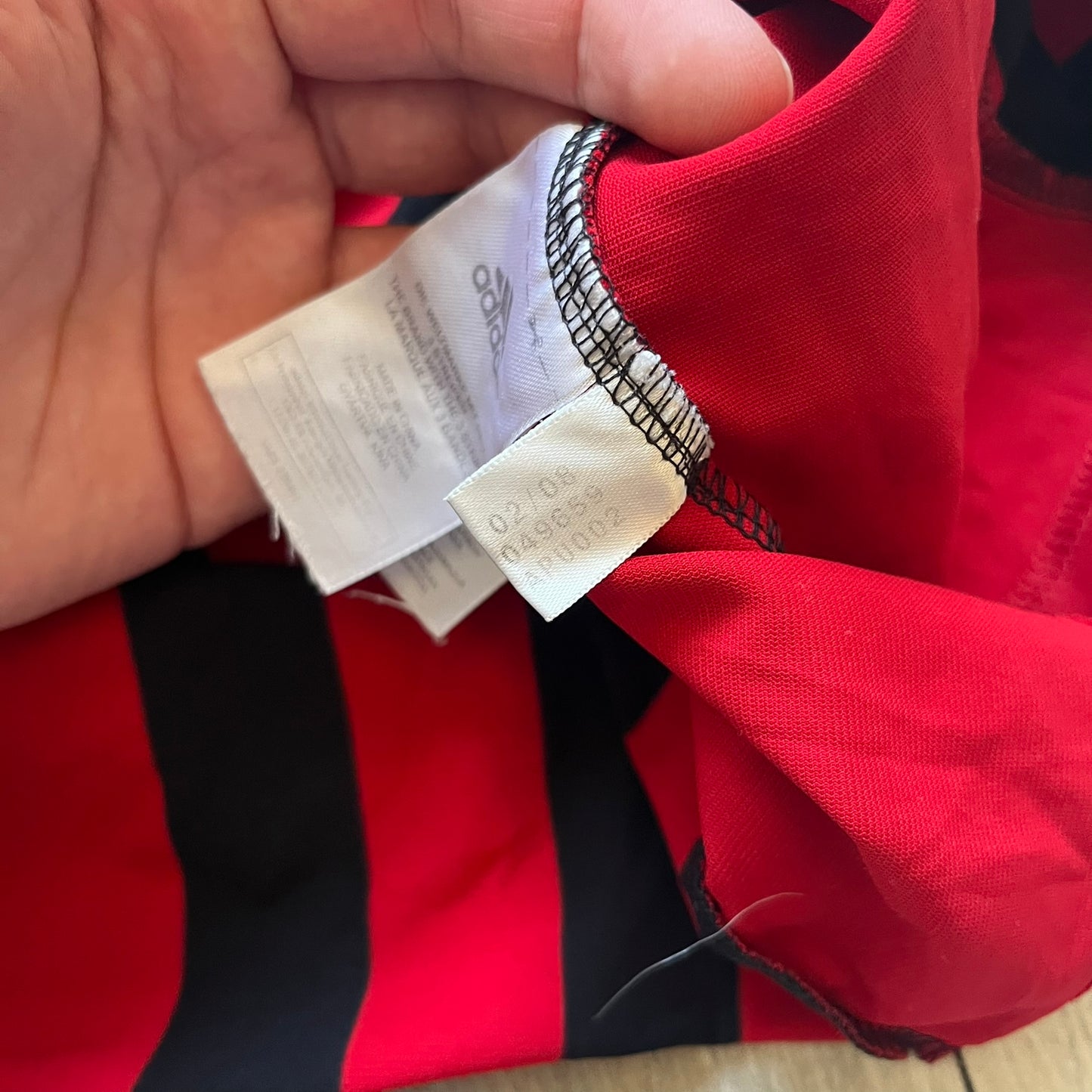 AC Milan Academy x Dolce &amp; Gabbana 2008/09 Home Tee is a black and red striped football shirt with black short sleeves. The chest features AC Milan Academy and Dolce &amp; Gabbana Junior logos on the sides, and a adidas logo in the center. Made with Clima365 technology.
