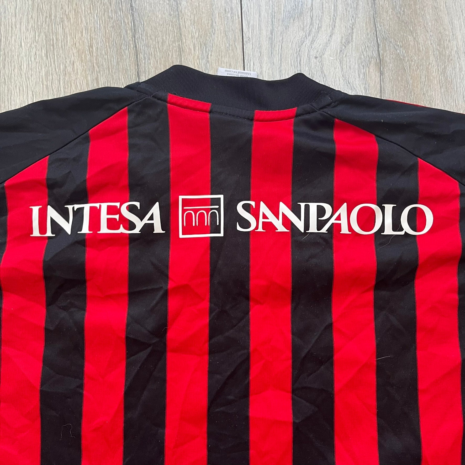 AC Milan Academy x Dolce &amp; Gabbana 2008/09 Home Tee is a black and red striped football shirt with black short sleeves. The chest features AC Milan Academy and Dolce &amp; Gabbana Junior logos on the sides, and a adidas logo in the center. Made with Clima365 technology.

