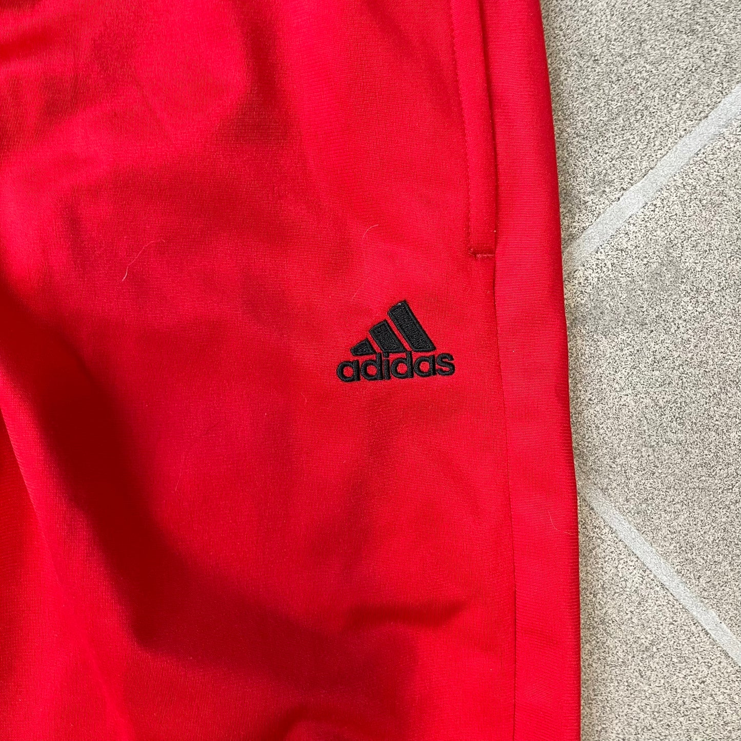 AC Milan x Adidas 2009/10 Junior Track Pants are a black and red junior football track bottoms with 3 black Adidas lines on the side. The right leg features AC Milan logo patch on one side, and Adidas logo embroidered on the left. Made with Climacool technology, it is designed for youth performance wear.