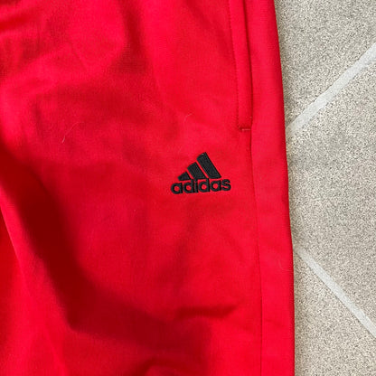 AC Milan x Adidas 2009/10 Junior Track Pants are a black and red junior football track bottoms with 3 black Adidas lines on the side. The right leg features AC Milan logo patch on one side, and Adidas logo embroidered on the left. Made with Climacool technology, it is designed for youth performance wear.
