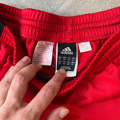 AC Milan x Adidas 2009/10 Junior Track Pants are a black and red junior football track bottoms with 3 black Adidas lines on the side. The right leg features AC Milan logo patch on one side, and Adidas logo embroidered on the left. Made with Climacool technology, it is designed for youth performance wear.