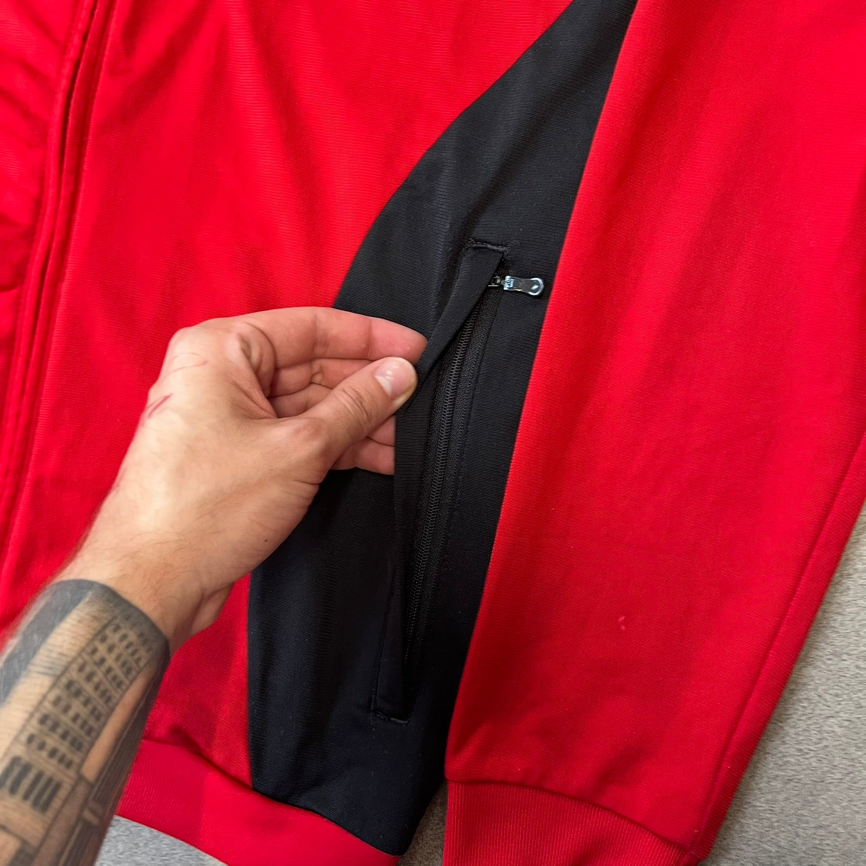 AC Milan x Dolce &amp; Gabbana 2009/10 Track Jacket is a black and red junior football track jacket with asymetrical black and red pattern. The chest features Adidas and D&amp;G Dolce &amp; Gabbana Junior logos on one side, and a AC Milan logo on the left. Made with Climacool technology, it is designed for youth performance wear.