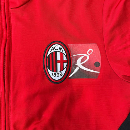 AC Milan x Dolce &amp; Gabbana 2009/10 Track Jacket is a black and red junior football track jacket with asymetrical black and red pattern. The chest features Adidas and D&amp;G Dolce &amp; Gabbana Junior logos on one side, and a AC Milan logo on the left. Made with Climacool technology, it is designed for youth performance wear.