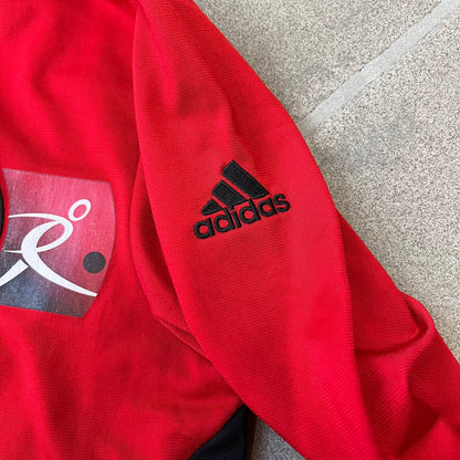 AC Milan x Dolce &amp; Gabbana 2009/10 Track Jacket is a black and red junior football track jacket with asymetrical black and red pattern. The chest features Adidas and D&amp;G Dolce &amp; Gabbana Junior logos on one side, and a AC Milan logo on the left. Made with Climacool technology, it is designed for youth performance wear.