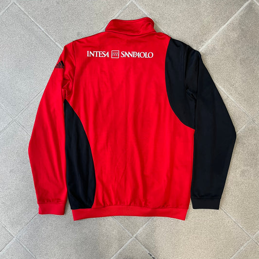 AC Milan x Dolce &amp; Gabbana 2009/10 Track Jacket is a black and red junior football track jacket with asymetrical black and red pattern. The chest features Adidas and D&amp;G Dolce &amp; Gabbana Junior logos on one side, and a AC Milan logo on the left. Made with Climacool technology, it is designed for youth performance wear.