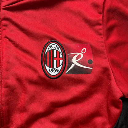 AC Milan x Dolce &amp; Gabbana 2009/10 Track Jacket is a black and red junior football track jacket with asymetrical black and red pattern. The chest features AC Milan and Adidas logos on one side, and a D&amp;G Dolce &amp; Gabbana Junior logo on the left. Made with Climacool technology, it is designed for youth performance wear.